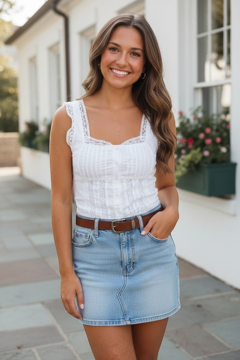 Mad-ly white lace square neck corset blouse with pleated bodice and ruffled cap sleeves worn with a denim skirt