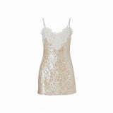 Mad-ly gold sequin mini dress with white lace trim, sweetheart neckline, and spaghetti straps on a white background.